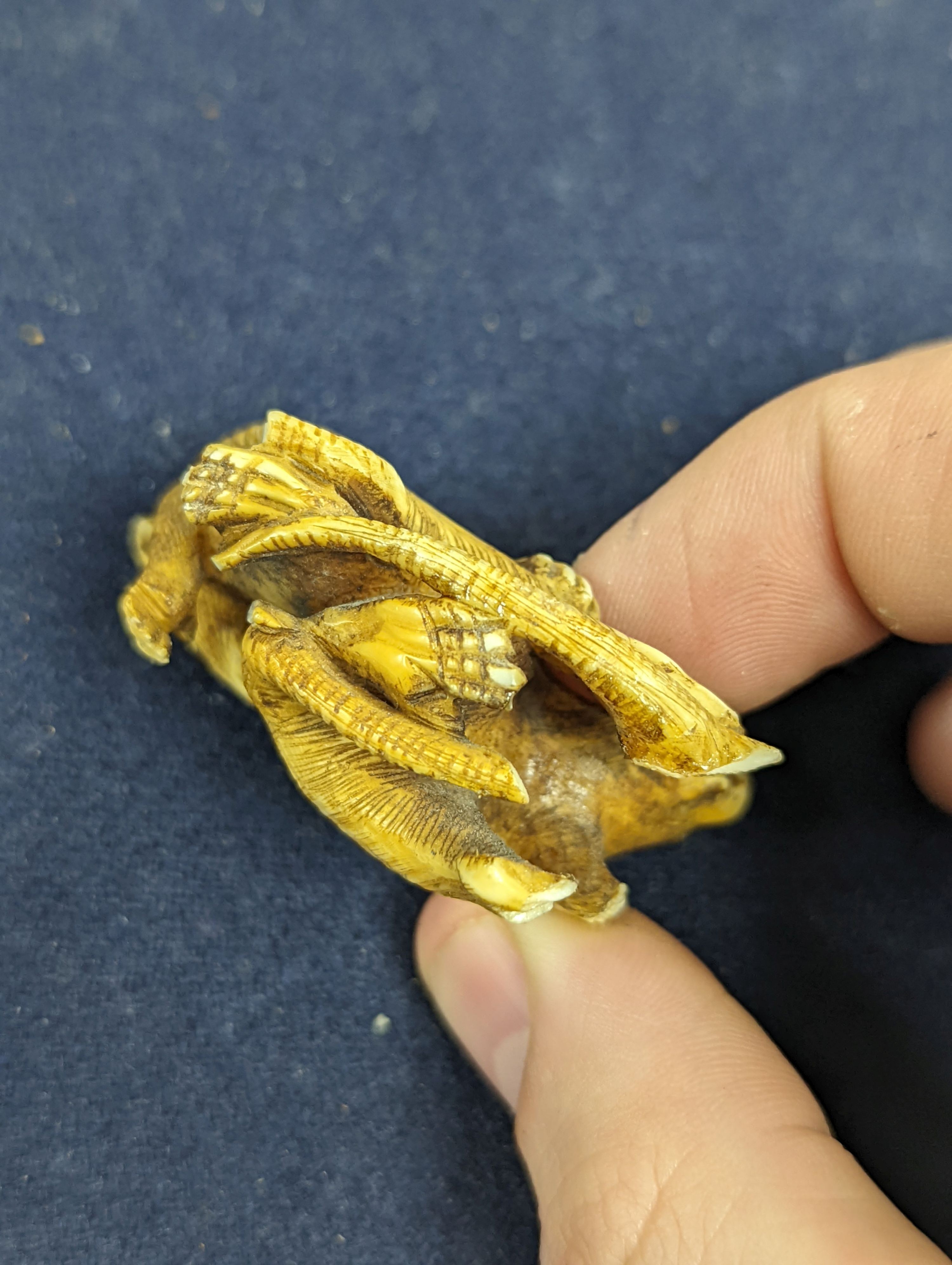 A collection of Japanese ivory and wood netsuke and okimono